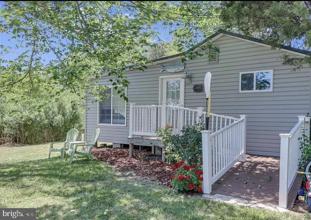 20805 Severn Road Ewell, MD 21824 - Photo 2 of 27 a view of a house with a yard and wooden fence