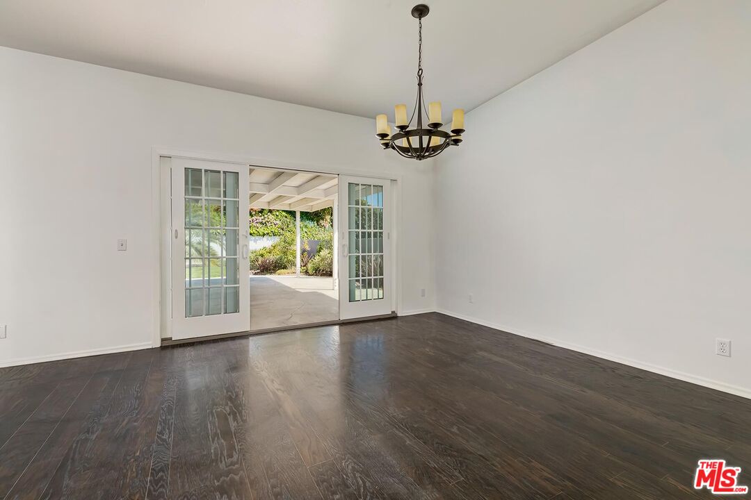 3736 Seahorn Drive Malibu, CA 90265 - Photo 14 of 17 a view of a room with wooden floor large windows and a chandelier