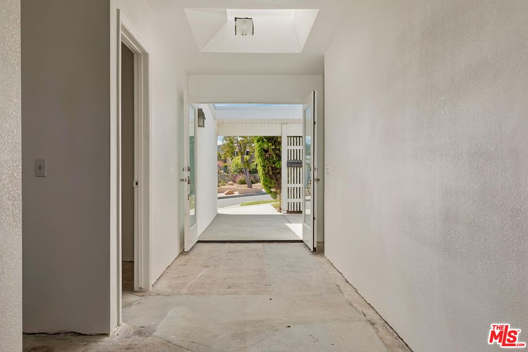 3736 Seahorn Drive Malibu, CA 90265 - Photo 10 of 17 a view of a hallway with wooden floor and a living room