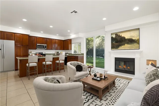 a living room with furniture kitchen view and a fireplace