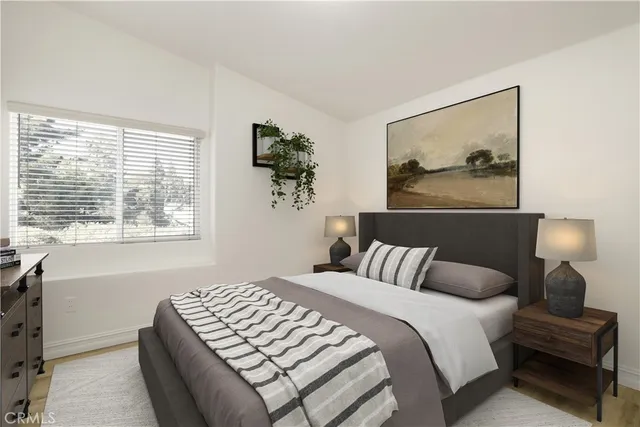 a bedroom with a bed and a painting on the wall