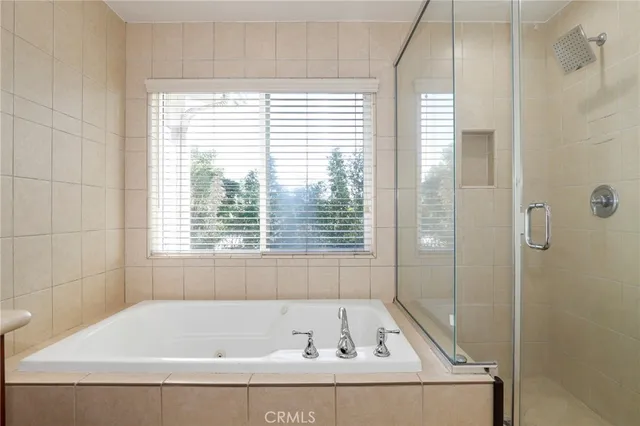 a bathroom with a bathtub and a shower