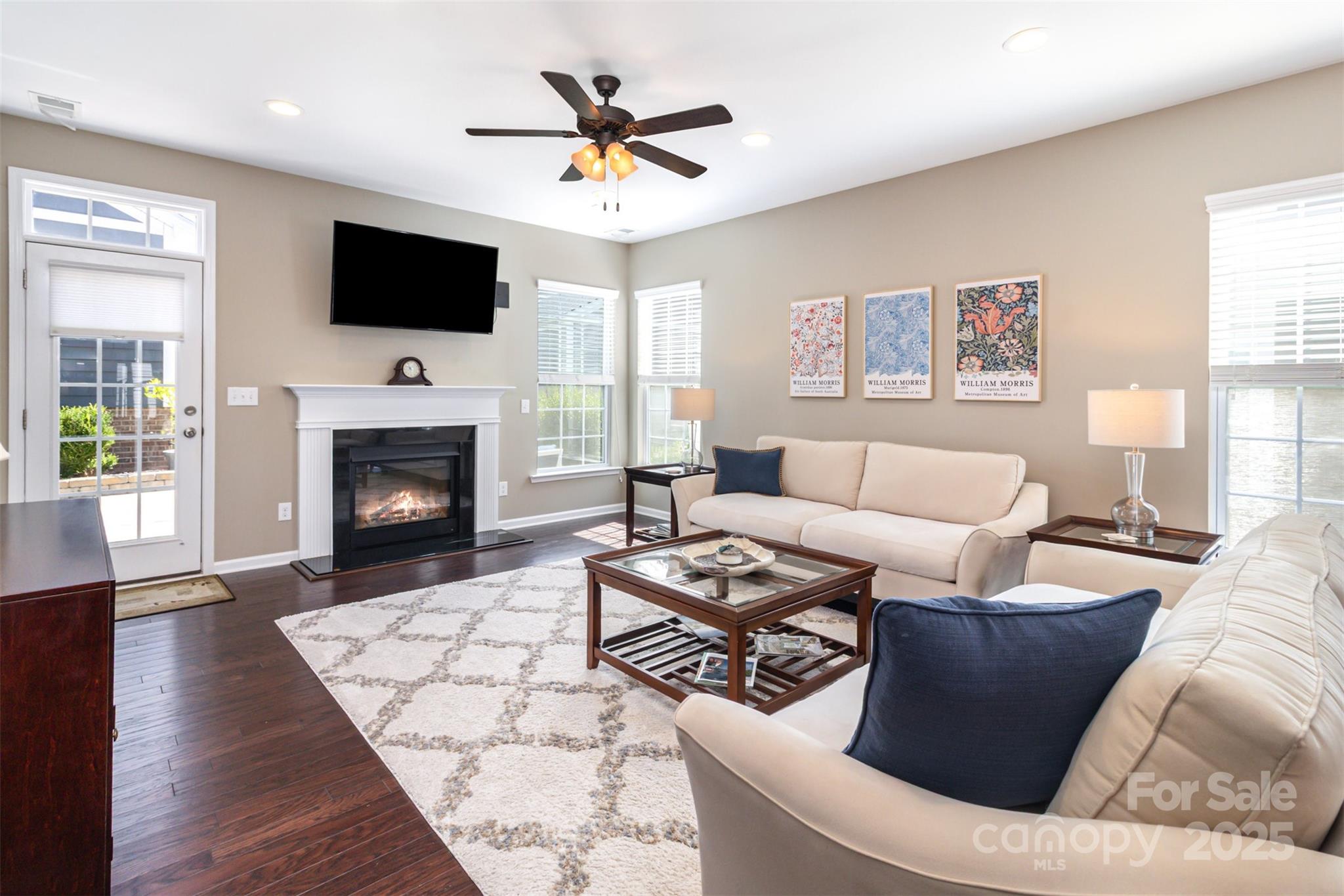 6187 Cloverdale Drive Tega Cay, SC 29708 - Photo 12 of 36 a living room with furniture a flat screen tv and a fireplace