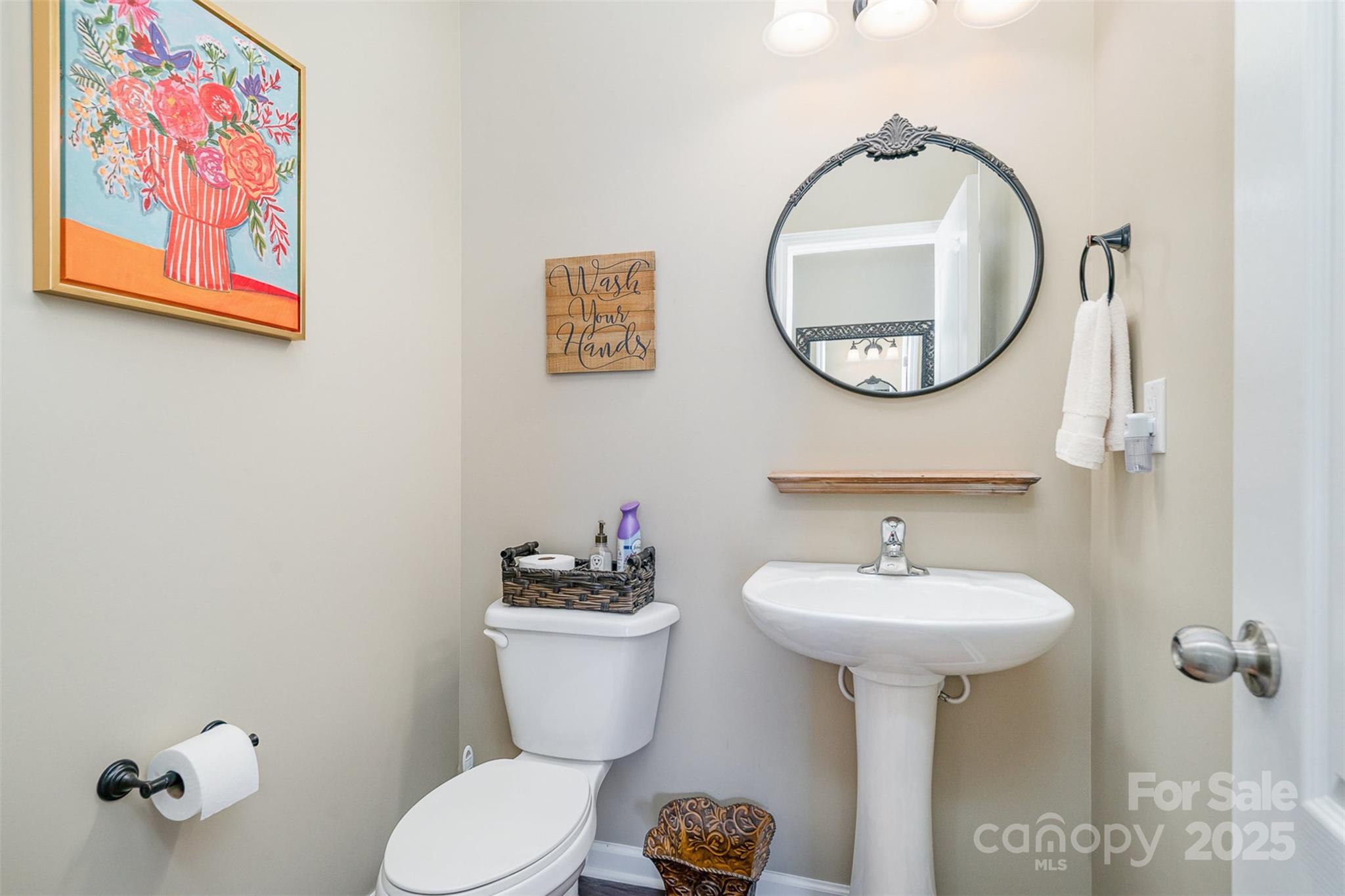 6187 Cloverdale Drive Tega Cay, SC 29708 - Photo 14 of 36 a bathroom with a toilet sink and mirror