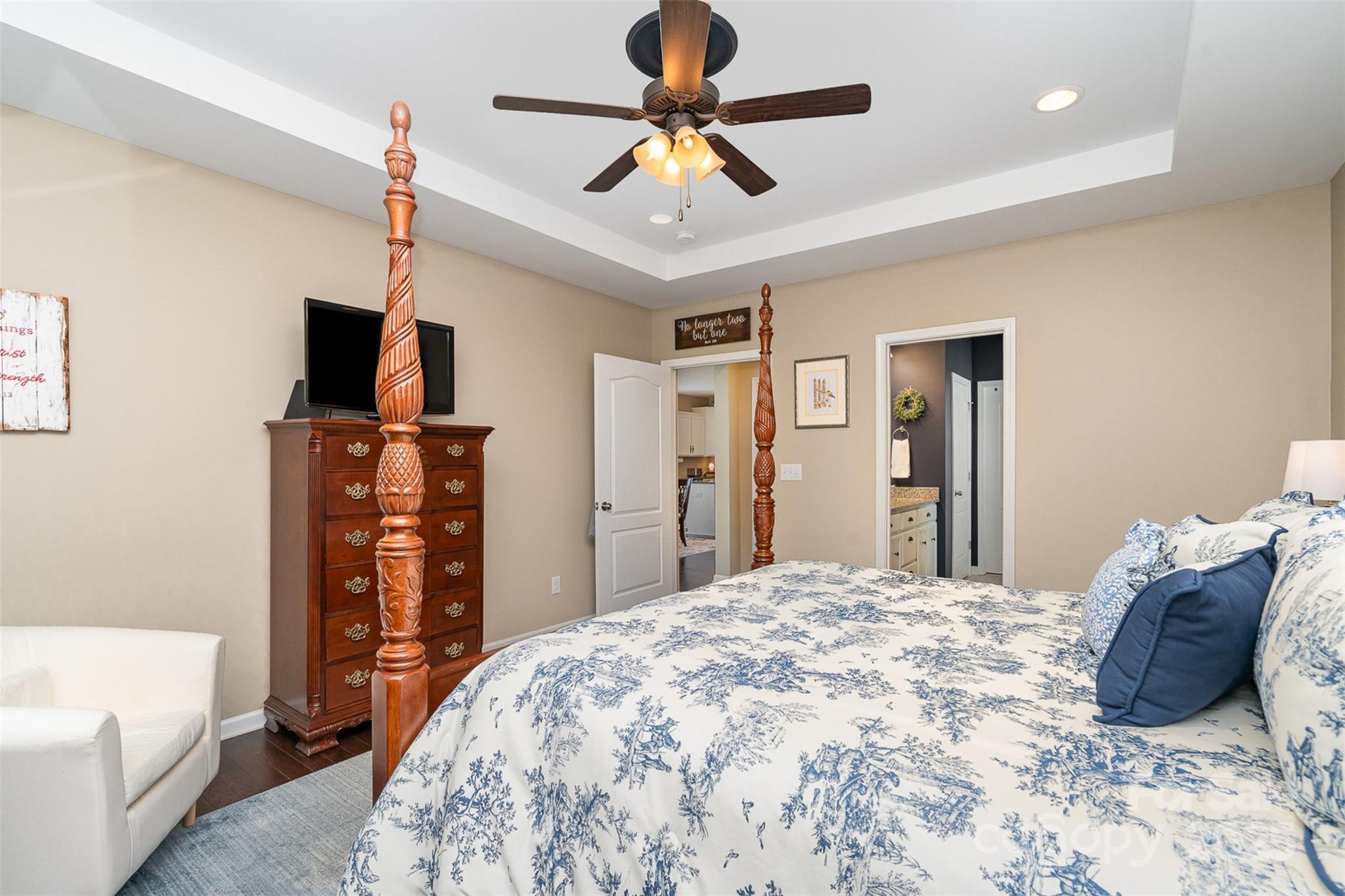 6187 Cloverdale Drive Tega Cay, SC 29708 - Photo 16 of 36 a bedroom with a bed and a flat tv screen on dresser