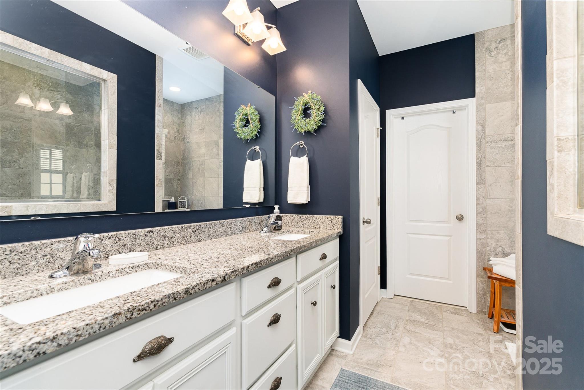 6187 Cloverdale Drive Tega Cay, SC 29708 - Photo 17 of 36 a bathroom with a granite countertop sink and a mirror