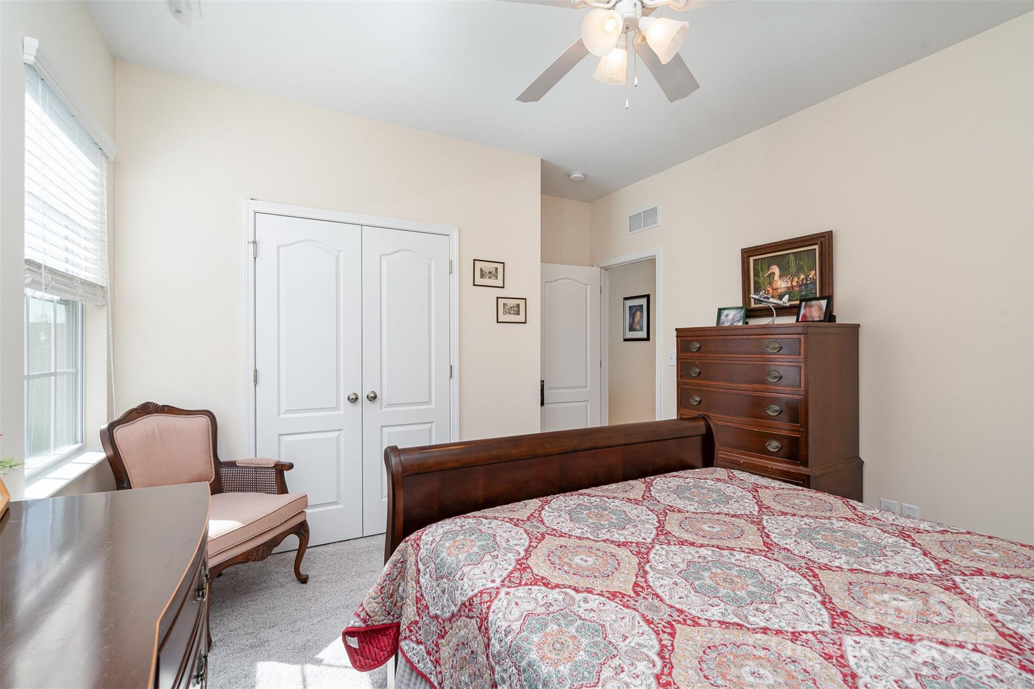 6187 Cloverdale Drive Tega Cay, SC 29708 - Photo 24 of 36 a bedroom with a bed and a chandelier