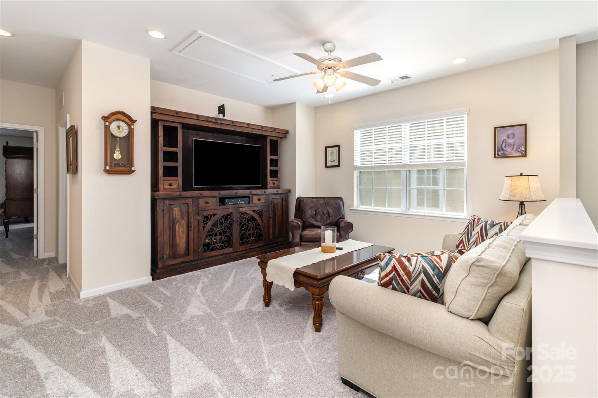6187 Cloverdale Drive Tega Cay, SC 29708 - Photo 30 of 36 a living room with furniture and a flat screen tv