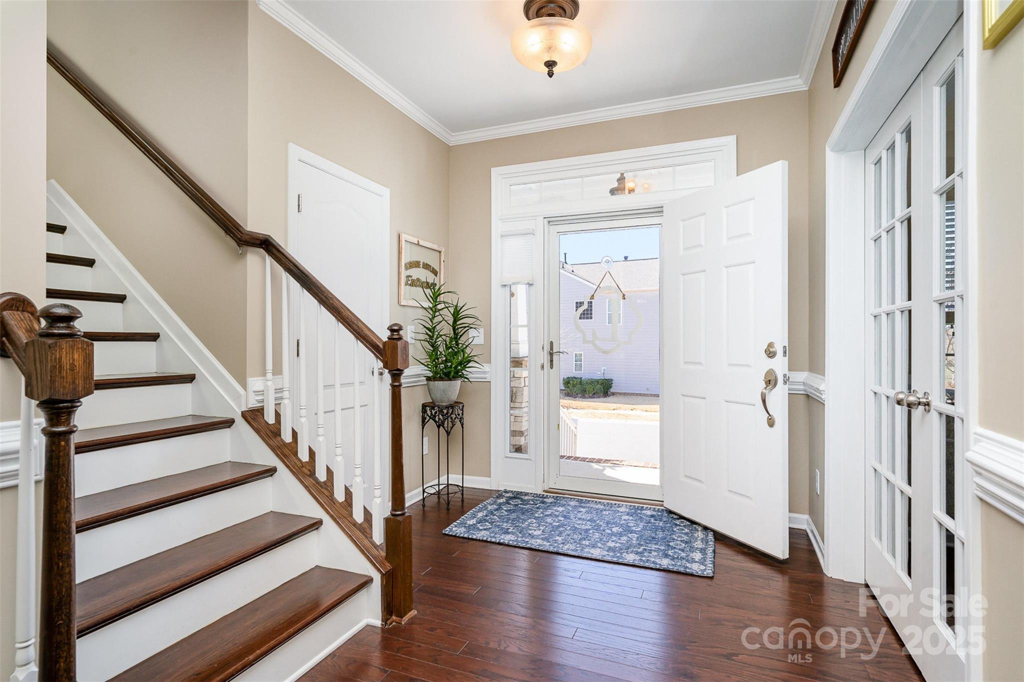 6187 Cloverdale Drive Tega Cay, SC 29708 - Photo 4 of 36 a view of a hallway with wooden floor and staircase