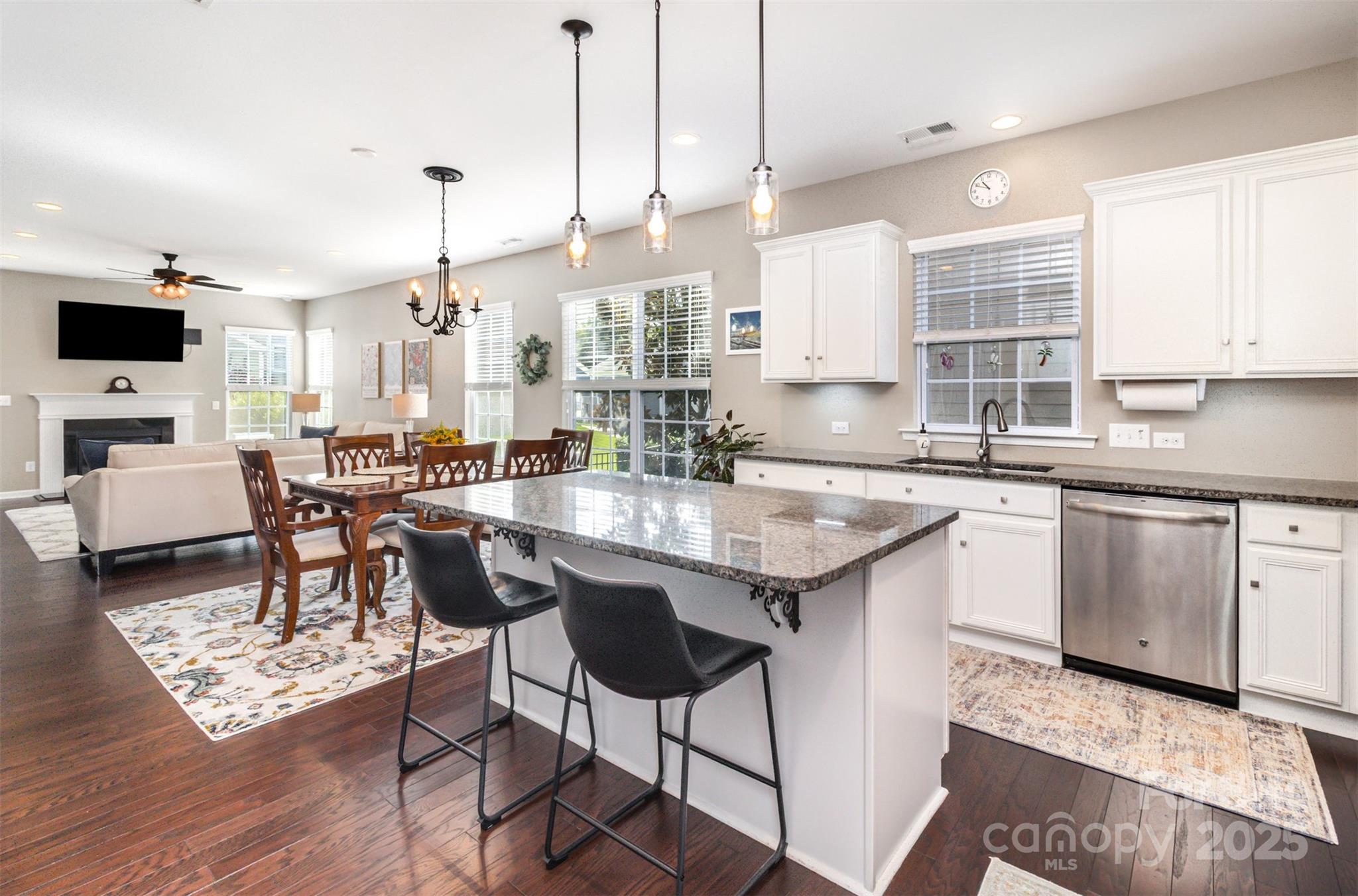 6187 Cloverdale Drive Tega Cay, SC 29708 - Photo 7 of 36 a kitchen with stainless steel appliances granite countertop a table chairs sink and cabinets