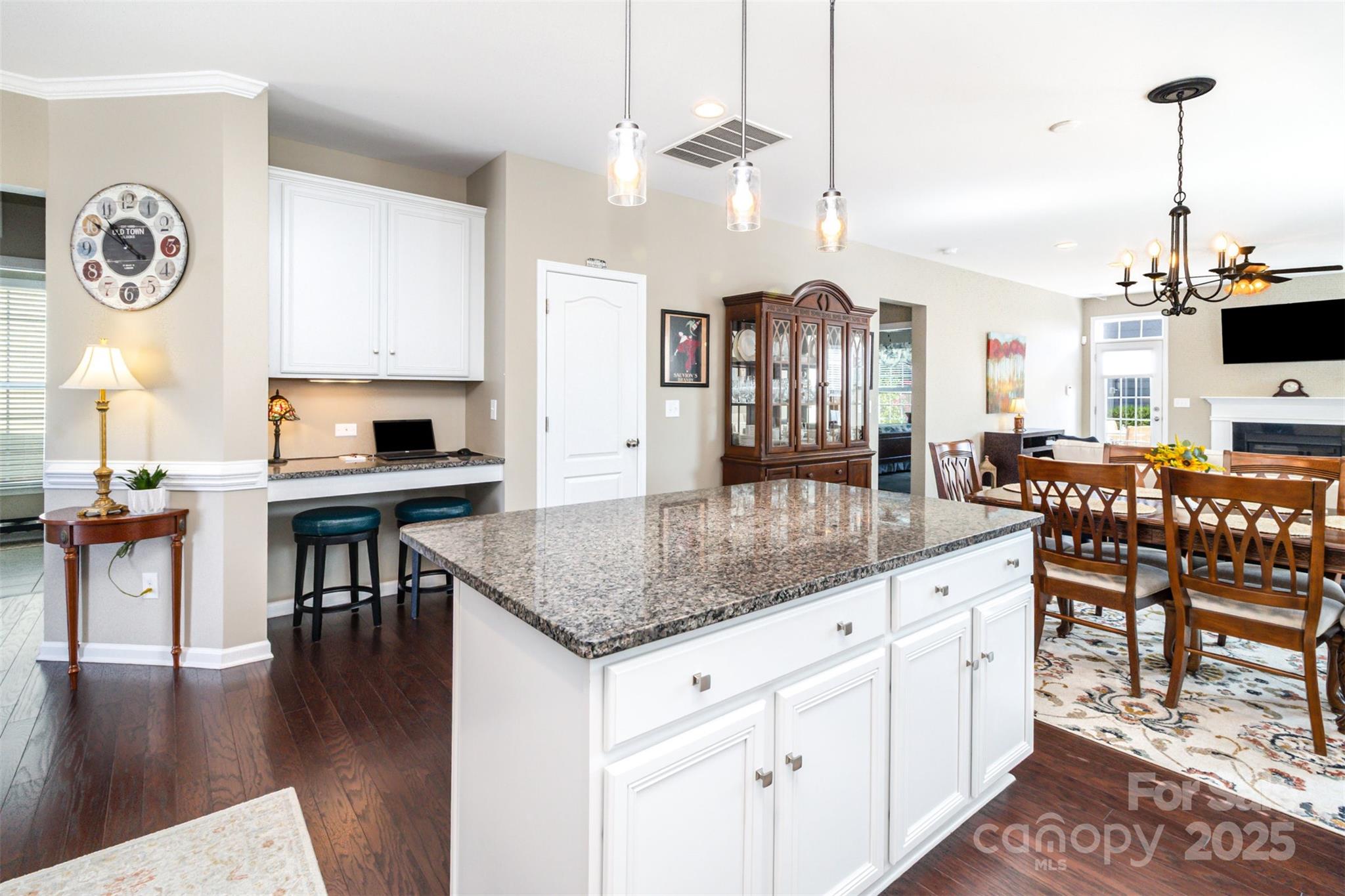 6187 Cloverdale Drive Tega Cay, SC 29708 - Photo 8 of 36 a kitchen with stainless steel appliances granite countertop a stove a refrigerator a kitchen island a dining table and chairs with wooden floor