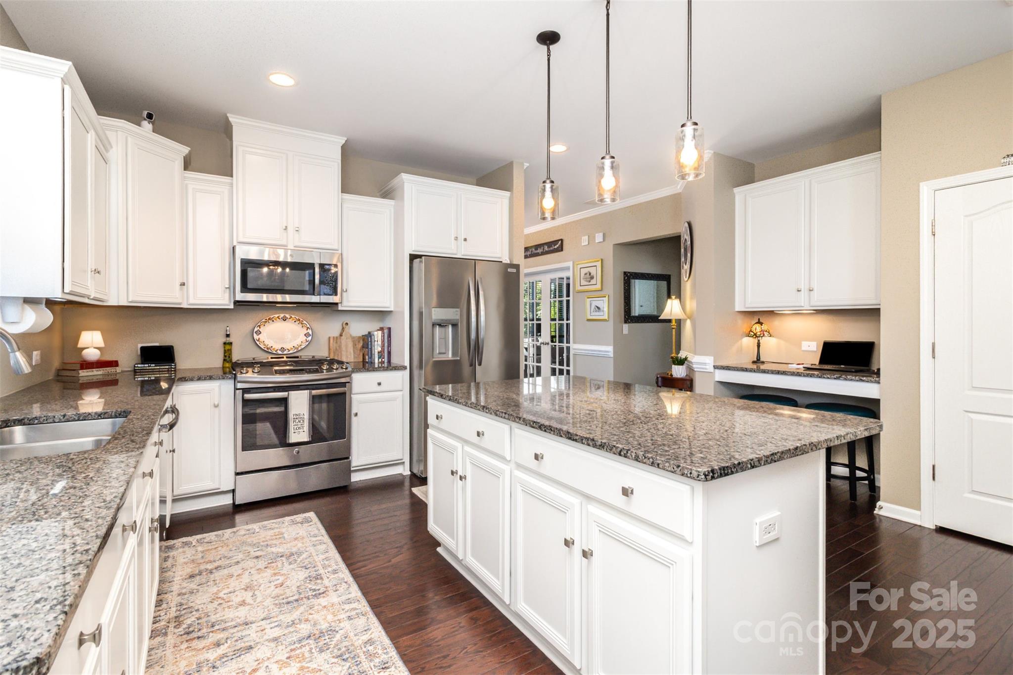 6187 Cloverdale Drive Tega Cay, SC 29708 - Photo 9 of 36 a kitchen with stainless steel appliances granite countertop a stove a sink and a refrigerator