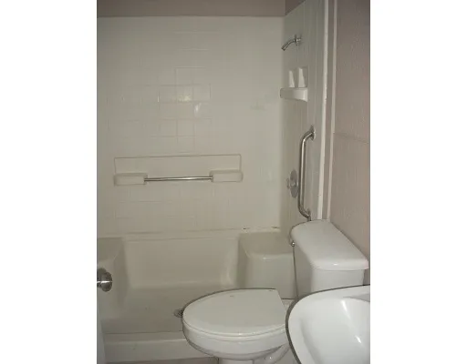 a white toilet next to a bathroom sink