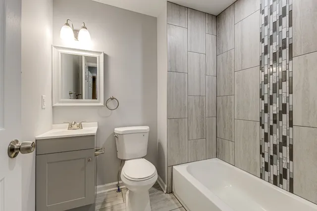 a kitchen with stainless steel appliances granite countertop a refrigerator and a stove