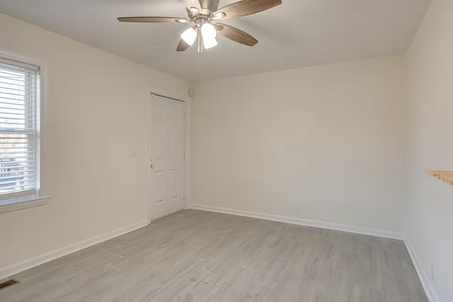 a view of a patio with table and chairs a barbeque with wooden floor and fence