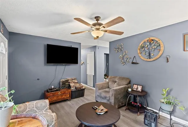 a living room with furniture and a chandelier