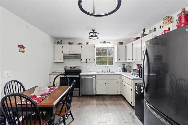 a kitchen with cabinets appliances and a window