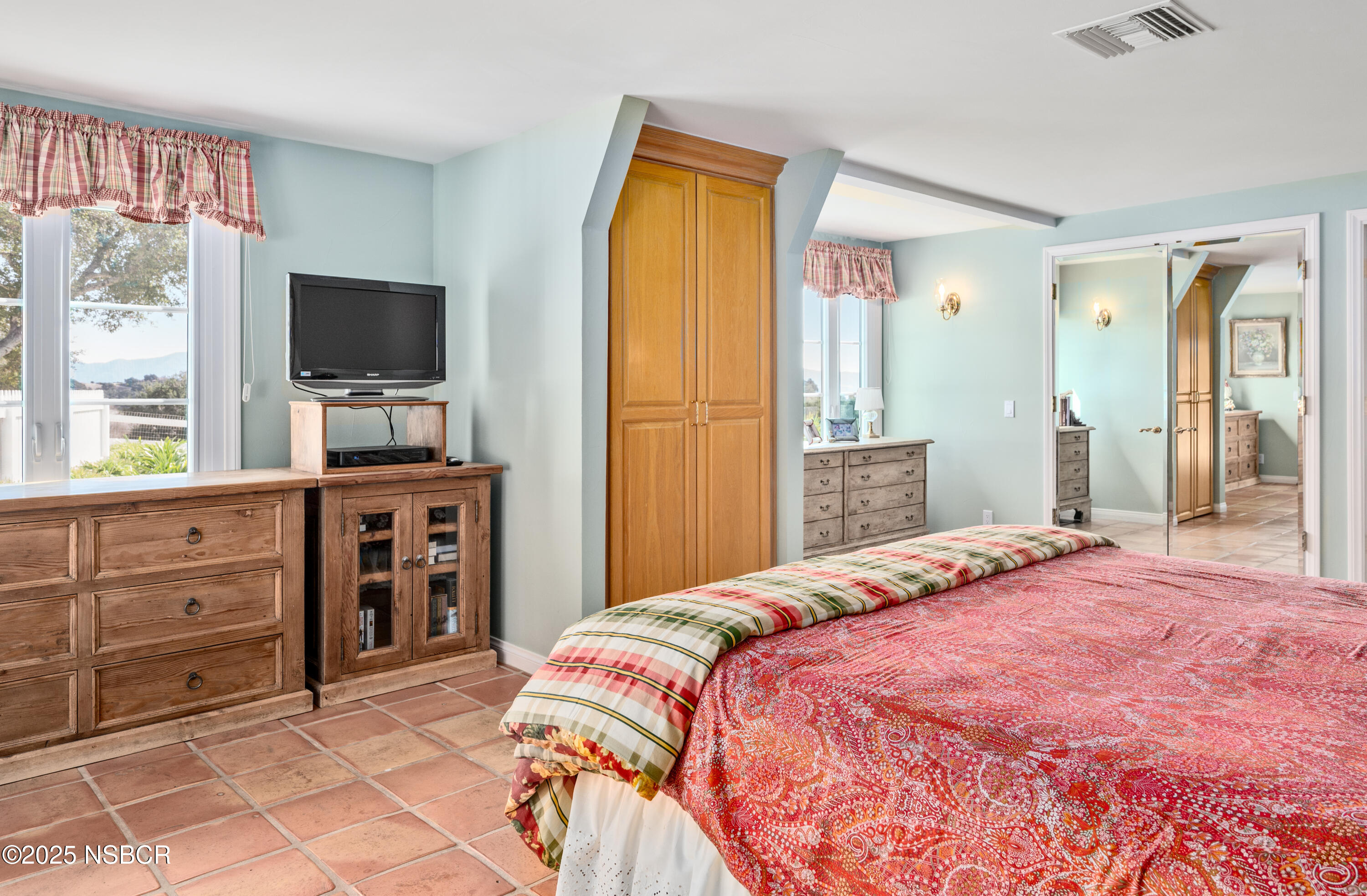 4086 East Oak Trail Road Santa Ynez, CA 93460 - Photo 18 of 57 a bedroom with a bed and a flat screen tv