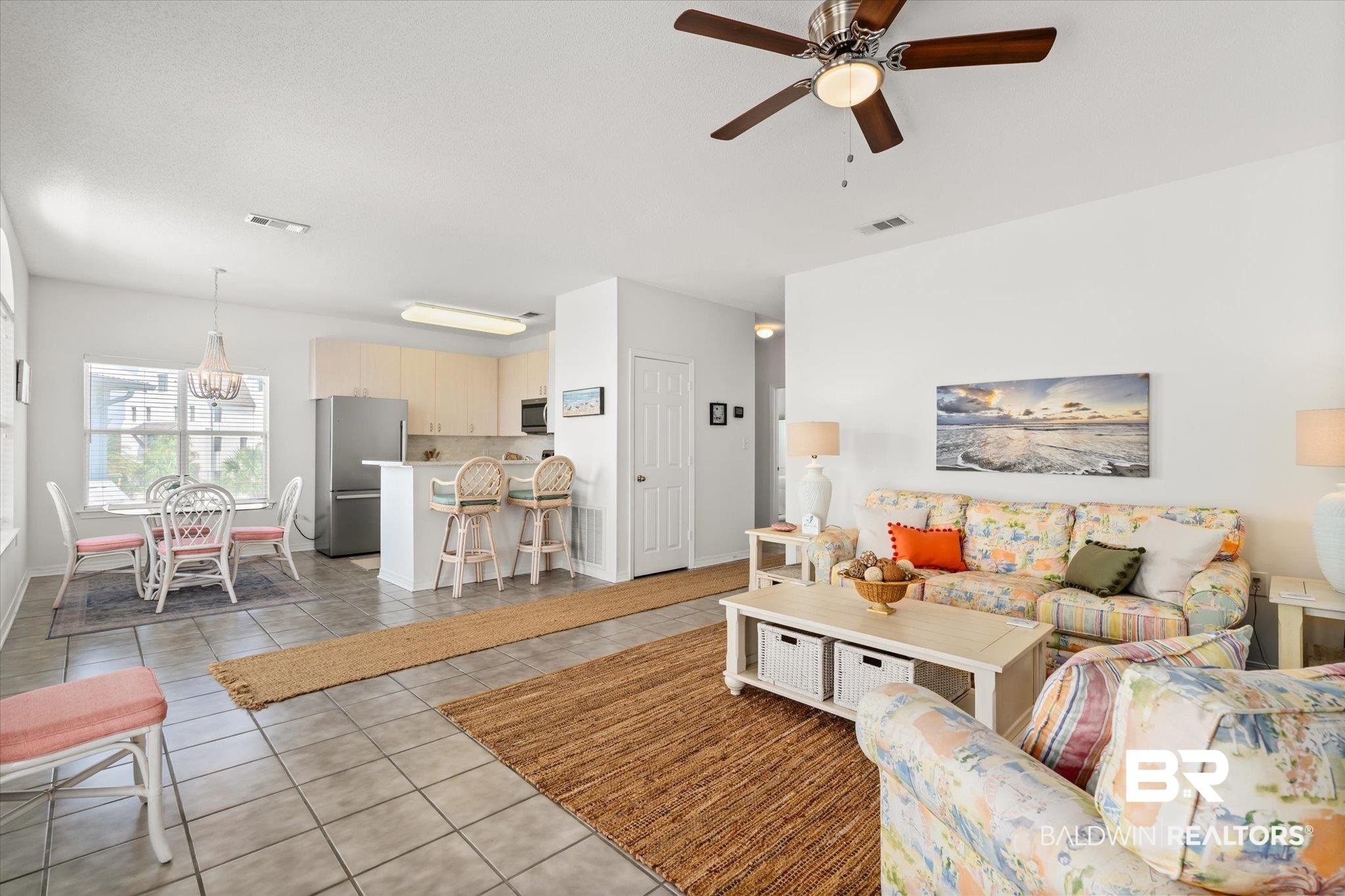 3575 Bayou Road, Unit A 10 Orange Beach, AL 36561 - Photo 6 of 31 Living room with ceiling fan & notable chandelier and light tile patterned floors
