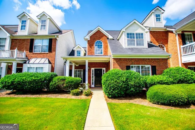 a front view of a house with a yard