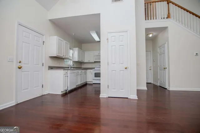 a view of kitchen with wooden floor and electronic appliances