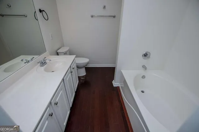 a view of a bathroom with a sink and wooden floor