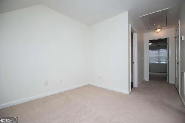 an empty room with closet and windows