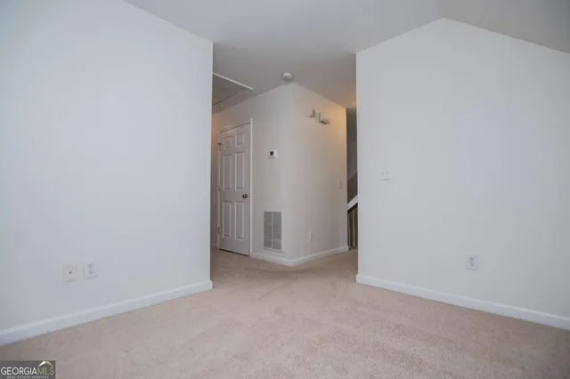 an empty room with closet area