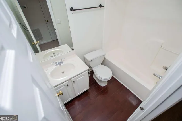 an empty room with cabinet and a bathroom