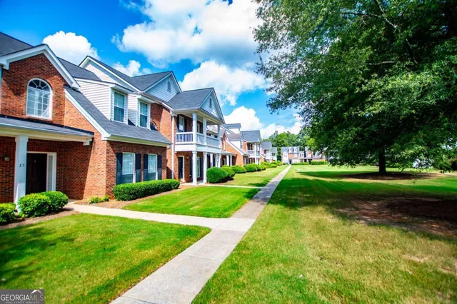 a view of a brick house with a yard