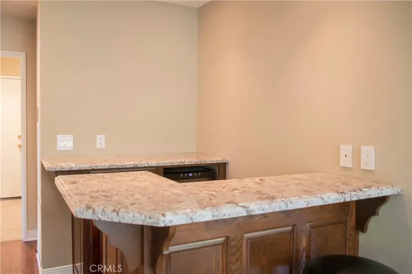 a bathroom with a granite countertop sink and white cabinets