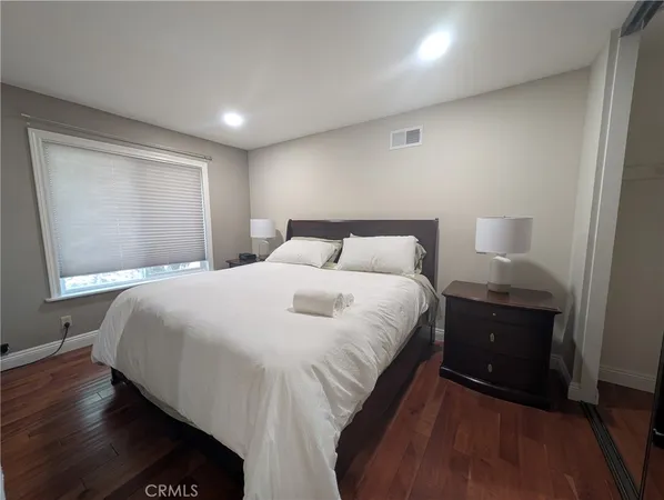 a bedroom with a bed and a window