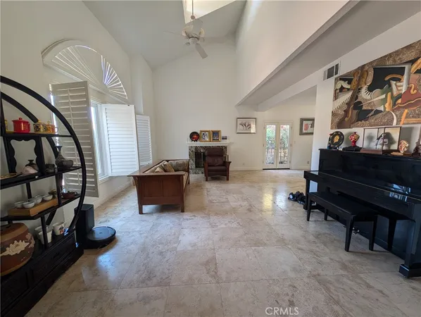 a living room with furniture and a book shelf