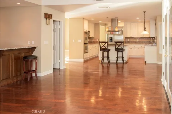 a view of a living room and kitchen with stainless steel appliances