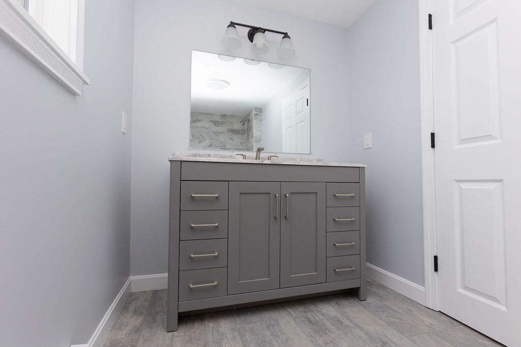 9 Rip Van Winkle Way Buzzards Bay, MA 02532 - Photo 14 of 56 a bathroom with a granite countertop sink and mirror