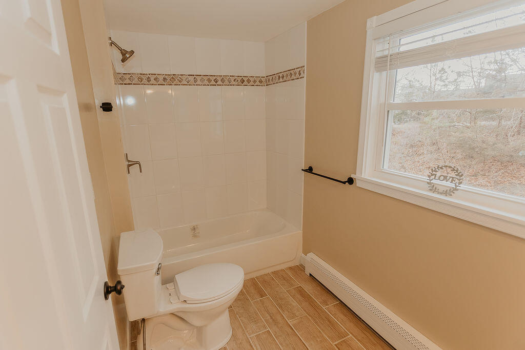 9 Rip Van Winkle Way Buzzards Bay, MA 02532 - Photo 36 of 56 a bathroom with a granite countertop white toilet and a shower