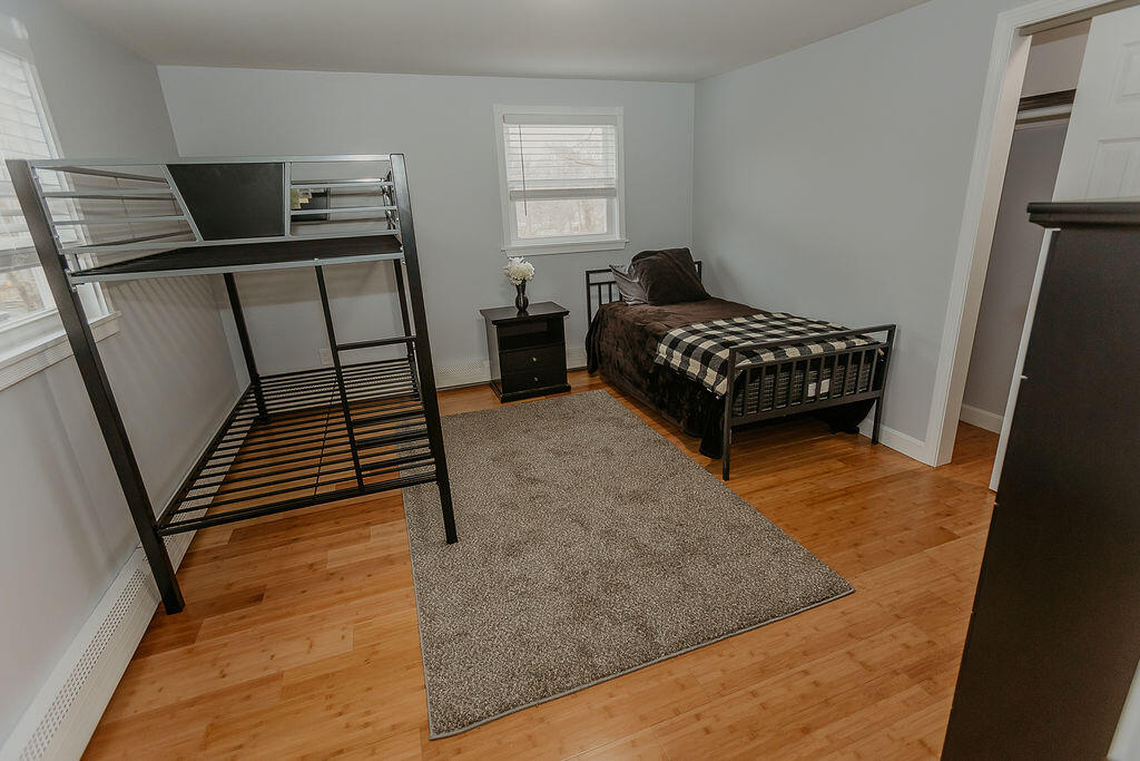 9 Rip Van Winkle Way Buzzards Bay, MA 02532 - Photo 44 of 56 a bedroom with a bed and wooden floor