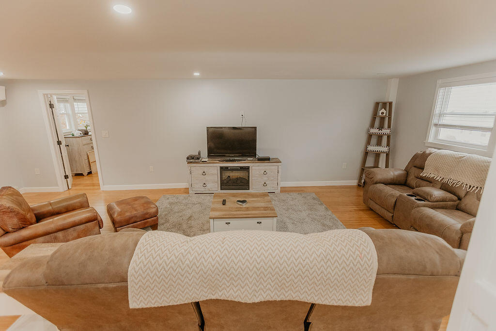 9 Rip Van Winkle Way Buzzards Bay, MA 02532 - Photo 8 of 56 a living room with furniture and a flat screen tv