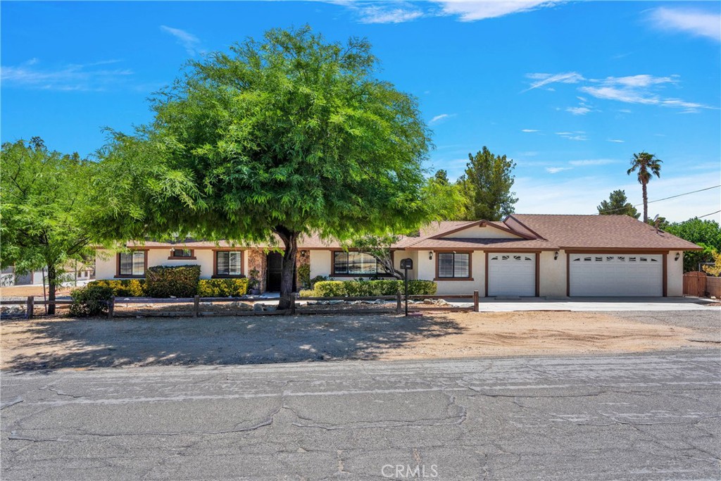 19095 Munsee Road Apple Valley, CA 92307 - Photo 1 of 58 a front view of a house with a yard and trees