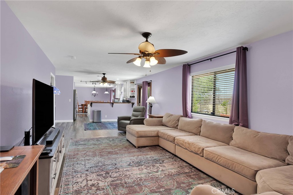 19095 Munsee Road Apple Valley, CA 92307 - Photo 16 of 58 a living room with furniture a chandelier and a flat screen tv