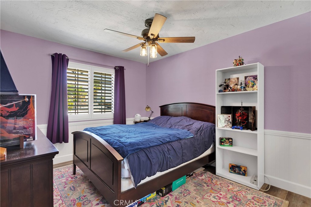 19095 Munsee Road Apple Valley, CA 92307 - Photo 18 of 58 a bedroom with a bed and a chandelier