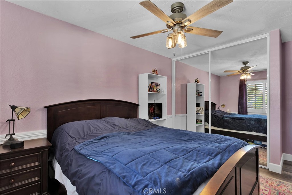 19095 Munsee Road Apple Valley, CA 92307 - Photo 19 of 58 a bedroom with a bed dresser and a chandelier