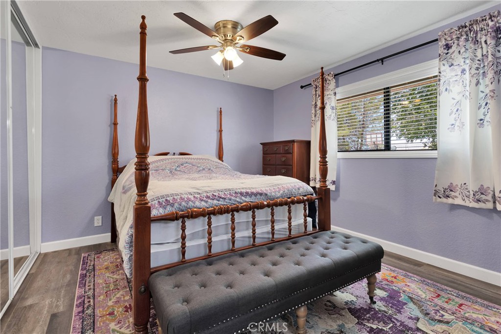 19095 Munsee Road Apple Valley, CA 92307 - Photo 23 of 58 a bedroom with a bed and a chandelier