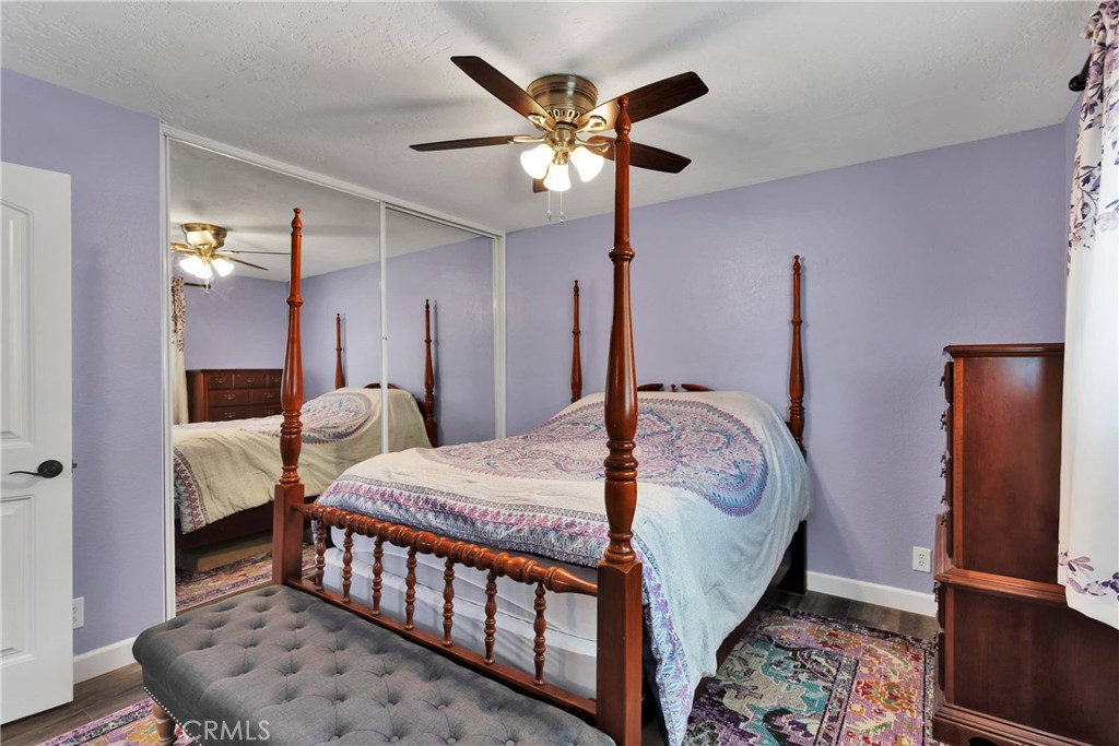 19095 Munsee Road Apple Valley, CA 92307 - Photo 24 of 58 a bedroom with bed and a chandelier