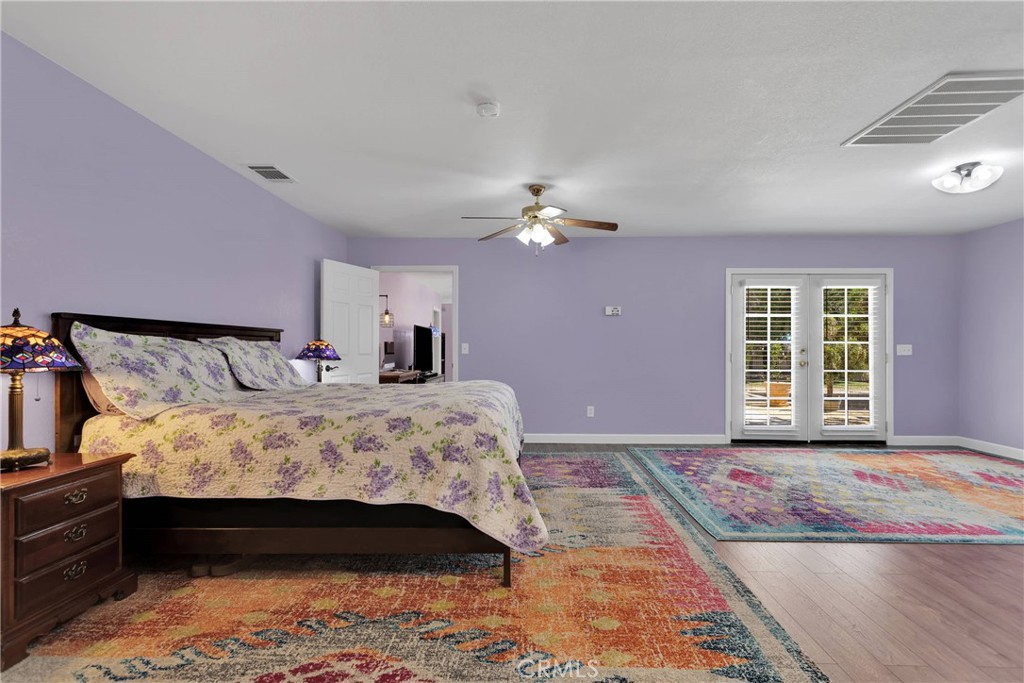 19095 Munsee Road Apple Valley, CA 92307 - Photo 29 of 58 a bedroom with a bed and a chandelier