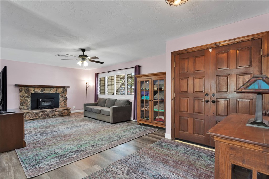 19095 Munsee Road Apple Valley, CA 92307 - Photo 3 of 58 a living room with furniture a fireplace and a flat screen tv