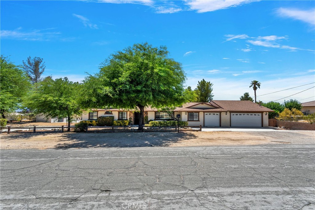 19095 Munsee Road Apple Valley, CA 92307 - Photo 48 of 58 a front view of a house with a yard and garage