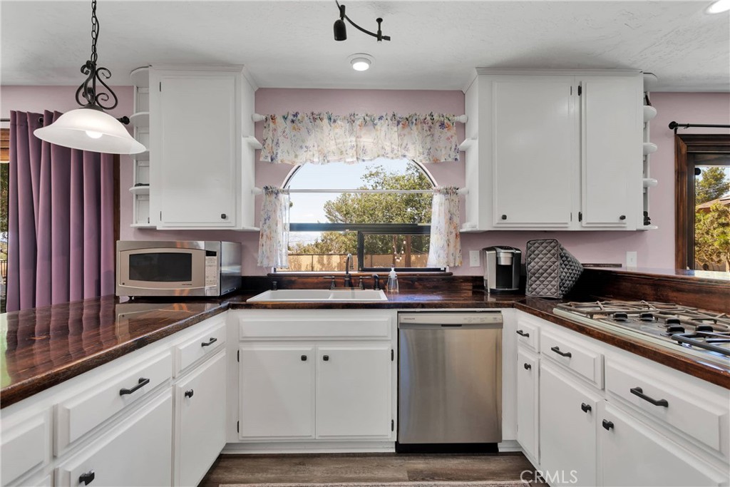 19095 Munsee Road Apple Valley, CA 92307 - Photo 8 of 58 a kitchen with granite countertop a sink stainless steel appliances and cabinets
