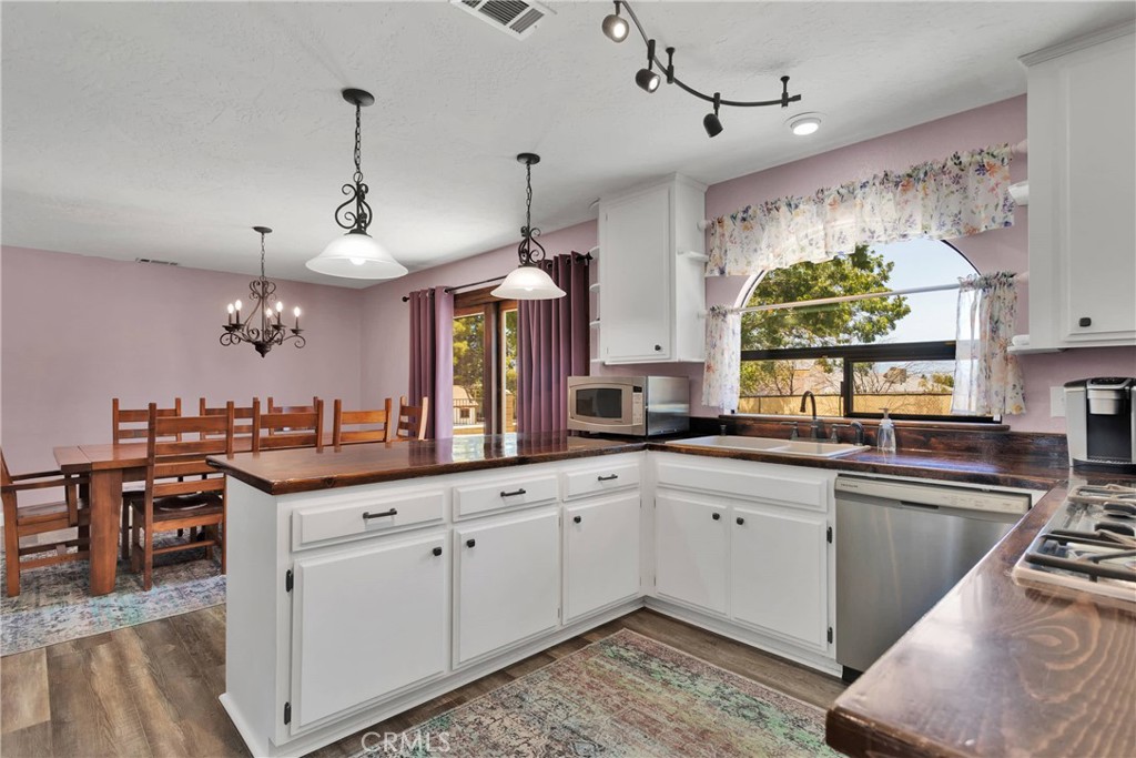 19095 Munsee Road Apple Valley, CA 92307 - Photo 9 of 58 a kitchen with stainless steel appliances granite countertop a sink and cabinets