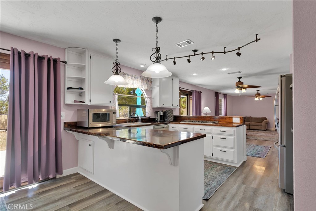 19095 Munsee Road Apple Valley, CA 92307 - Photo 10 of 58 a kitchen with granite countertop a sink cabinets and wooden floor